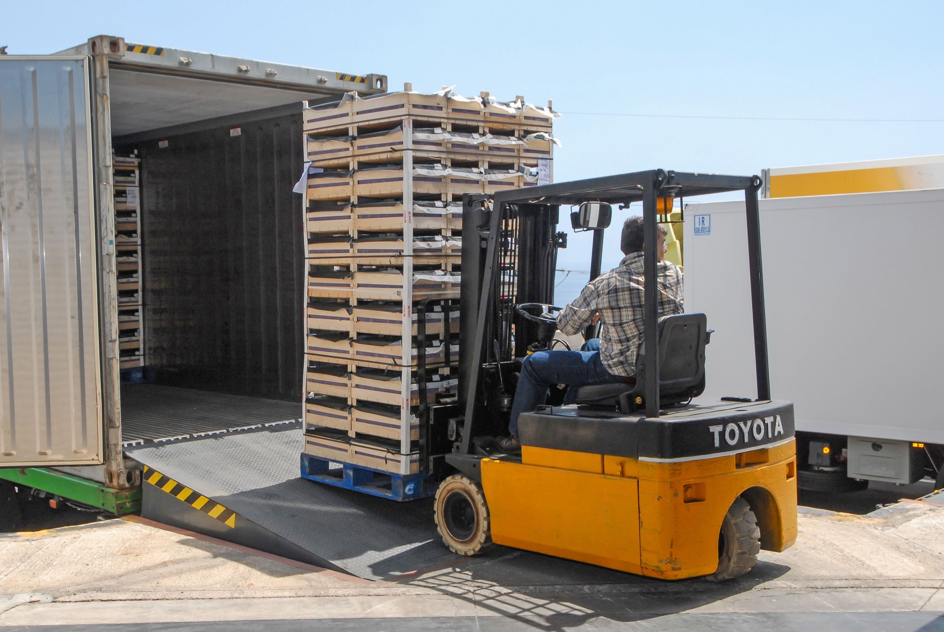 Forklift removing goods from a container